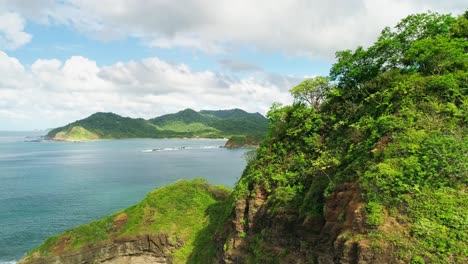 Sideways-drone-establisher,-picturesque-panorama-coastline-Nicaragua,-sunny-day
