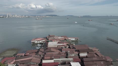 Chew-Jetty:-Buildings-on-stilts-on-Malaysian-city-waterfront,-aerial