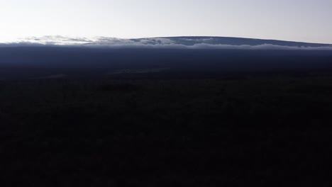 Aerial-wide-rising-shot-of-the-volcano-Mauna-Loa-revealed-above-the-clouds-at-sunset-on-the-Big-Island-of-Hawai'i
