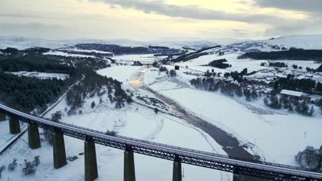 Aerial-panoramic-view-of-winter-landscape-covered-with-snow-at-dusk