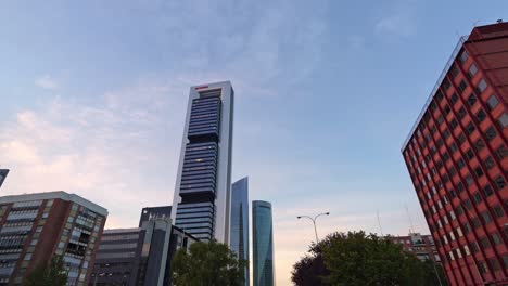 Tilt-down-view-of-skyscrapers-buildings-cinco-torres-during-sunset-in-Madrid,-Spain-Cinco-torres-business-area-and-Paseo-de-la-castellana-street