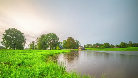 Timelapse-Yellow-Sunset-Day-to-Night-Evening-Thunderstorm-Over-Lake-and-Countryside,-Latvia