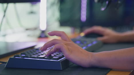 Close-Up-Of-Frustrated-Female-Gamer-Using-Computer-Keyboard-And-Mouse-For-Live-Stream