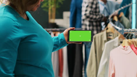 Woman-analyzing-phone-with-greenscreen