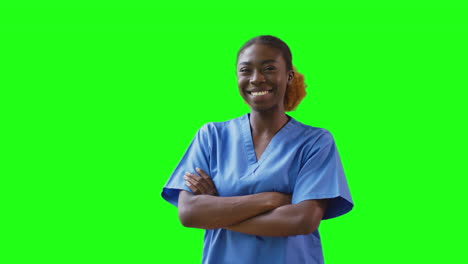Portrait-Of-Female-Nurse-Or-Doctor-Wearing-Scrubs-Against-Green-Screen