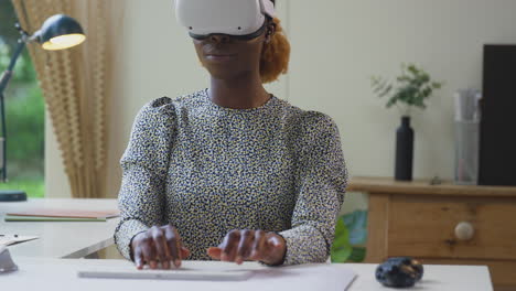 Woman-Working-From-Home-Office-Sitting-At-Desk-Wearing-VR-Headset-Using-AR-Technology