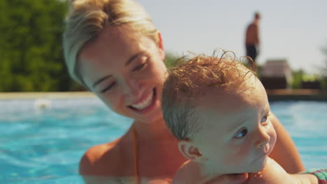 Baby-Boy-With-Mother-On-Family-Summer-Holiday-Having-Fun-Swimming-In-Pool