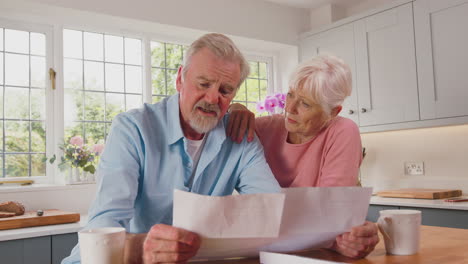 Worried-Retired-Senior-Couple-Looking-At-Bills-At-Home-Concerned-About-Cost-Of-Living