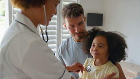 Nurse-Wearing-Uniform-Listening-To-Girl-Patient's-Chest-With-Stethoscope-In-Private-Hospital-Room