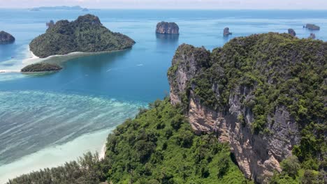 Towering-mountain-with-islands,-and-coral-reef,-Krabi,-Thailand