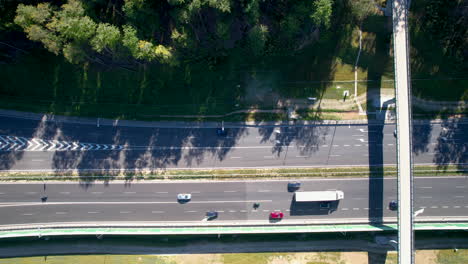 Aerial-top-down-shot-of-cars-on-polish-highway-with-passenger-bridge-in-Gdynia-City-Suburb