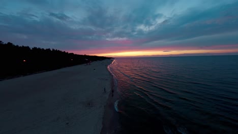 FPV-drone-flying-fast-over-the-waves-of-the-Baltic-Sea-in-Poland-at-sunset,-Pomerania-region,-polish-seaside