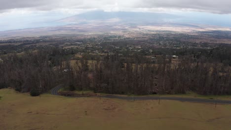 Aerial-dolly-tilting-up-shot-of-Kahului-and-West-Maui-from-the-slopes-of-Haleakala-on-the-Hawaiian-island-of-Maui
