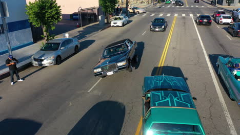 Aerial-view-of-a-car-doing-suspension-tricks-on-the-streets-of-Los-Angeles,-USA