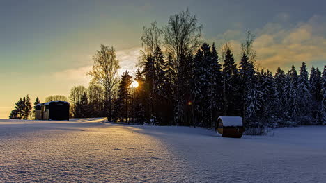 Warm-Sunlight-Over-Scenic-Winter-Forest-Silhouette-with-Barrel-Sauna,-Timelapse