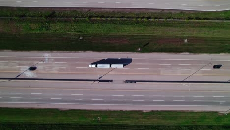 top-down-aerial-of-multi-trailer-truck-driving-on-Interstate-90