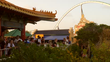 Public-in-the-hope-line-for-Dragon-Khan,-an-old-roller-coaster-that-sets-world-records-at-Port-Aventura-Amusement-Park