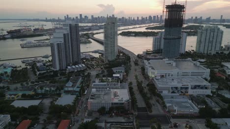 South-beach-aerial-skyline-at-sunset-with-downtown-cityscape-at-distance-drone-footage