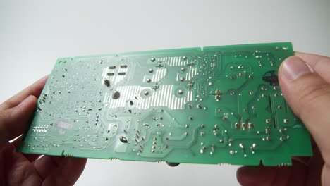 Close-up-of-circuit-board-components-under-a-thorough-inspection-by-an-expert-technician