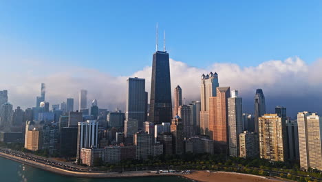 Aerial-view-around-the-Chicago-skyline,-sunrise-with-clouds-in-the-background