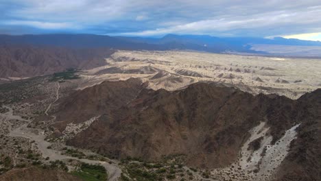 Drone-shot-flying-towards-the-Tatón-Dunes-in-Caramarca,-Argentina-on-an-overcast-day