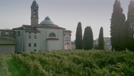The-rows-of-vines-next-to-the-church-of-Rosciate,-Terra-del-Moscato-di-Scanzo,-Scanzorosciate