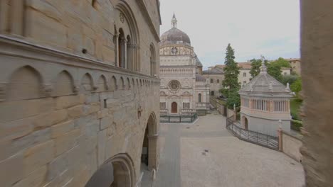 Low-altitude-drone-Flight-passing-through-the-staircase-of-Palazzo-della-Ragione,-in-upper-Bergamo,-approaches-the-Colleoni-chapel