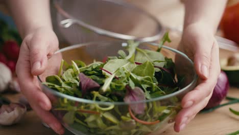Close-up-woman-making-healthy-salat-at-home.