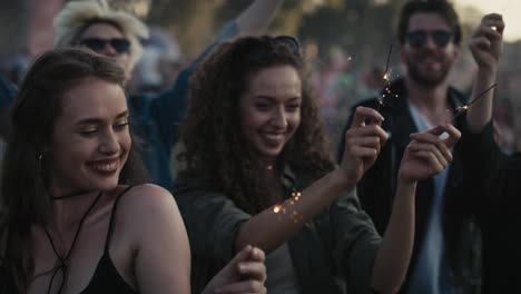 Group-of-caucasian-young-people-dancing-on-music-festival-with-sparklers