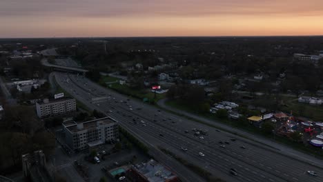 Aerial-view-of-Traffic-on-Downtown-Connector-Interstate-mega-highway-during-rush-hour-at-sunset