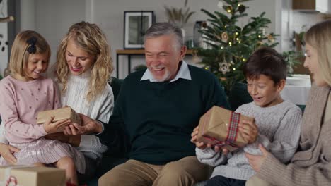 Caucasian-grandfather-giving-Christmas-presents-for-his-grandchildren.