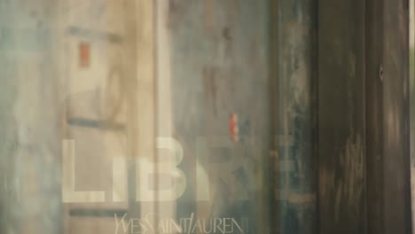 Shop-windows-reflecting-office-people-walking-on-the-street,-closeup