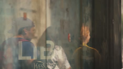 Window-reflecting-people-walking-on-the-street