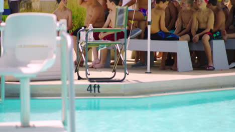 Group-of-kids-by-swimming-pool-enjoying-socialising-activities-in-water-park