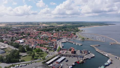 Small-port-city-Simrishamn-in-the-Swedish-countryside,-aerial-establisher