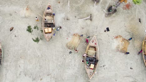 Fishermen-On-The-Shore-With-Boats,-Preparing-Fishing-Nets-In-Daytime