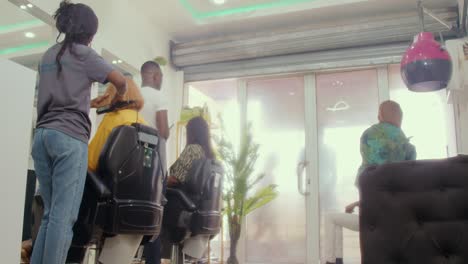 Low-angle-view-of-African-American-couple-customers-walking-into-a-hair-saloon