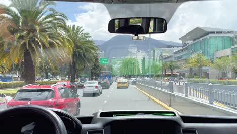 Filming-out-of-Car-in-Traffic-of-Quito-Downtown-with-Mountain-View,-Ecuador