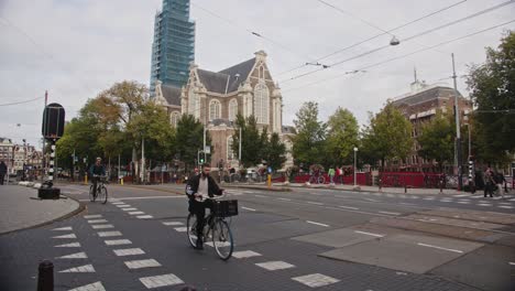 Slow-motion-of-traffic-and-cyclist-on-street-in-Amsterdam,-the-Netherlands