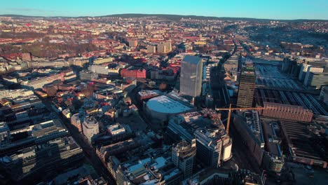Drone-Shot-of-Downtown-Oslo,-Norway,-Central-Train-Station-and-Buildings-on-Sunny-Day