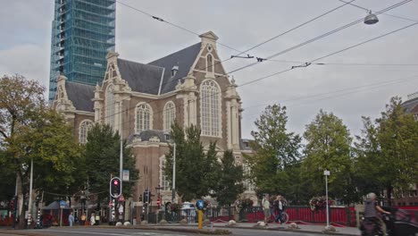 Tilt-up-from-road-to-Westerkerk-with-the-tower-under-renovation-in-Amsterdam,-the-Netherlands