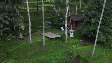 Tourist-swings-on-giant-rice-field-swing-at-Santana-Terrace-in-Bali