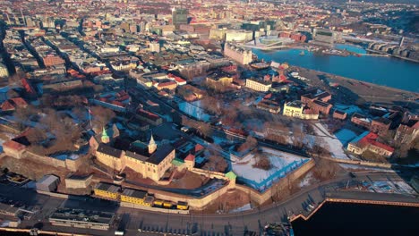 Aerial-drone-View-of-Oslo,-Norway,-Akershus-Fortress-and-Downtown-on-Sunny-Autumn-Day
