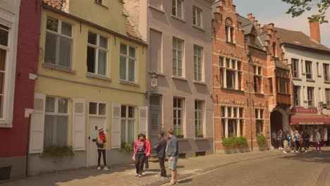 Tourists-walking-in-historic-center-preserved-by-UNESCO-in-Bruges,-Belgium