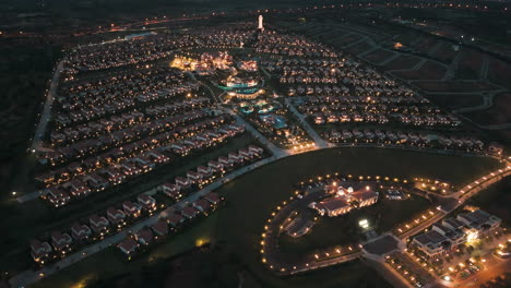 Romantic-illumination-of-luxury-Centara-Mirage-resort,-Mui-Ne,-Vietnam-at-night,-aerial