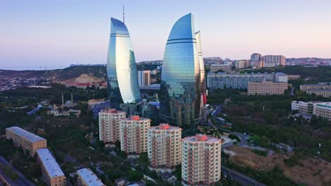 TV-tower-of-Baku-and-futuristic-glass-skyscrapers,-landmarks-of-Azerbaijan-at-sunset-dawn