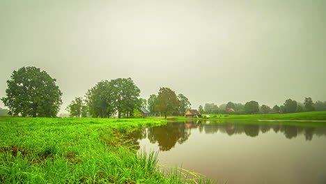 Fresh-Misty-Morning-Atmosphere-Over-Rural-Village-Near-Calm-Lake