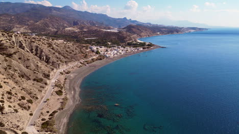 Drone-aerial-of-Beach-In-Crete,-Greece-at-city-Mirtos