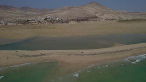 Sotavento-Beach,-Fuerteventura:-wonderful-aerial-view-traveling-out-to-the-fantastic-beach-and-beautiful-mountain