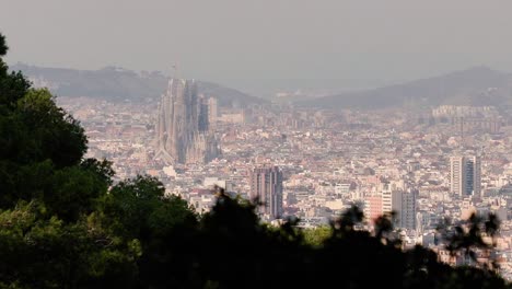 Distant-View-of-Barcelona's-Iconic-Sagrada-Familia:-A-Zoomed-In-Perspective-Amidst-the-City's-Urban-Landscape
